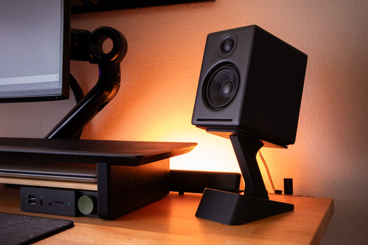 3d printed raised speaker stand with hidden storage, holding the audio engine A2+ speakers on a back lit desk