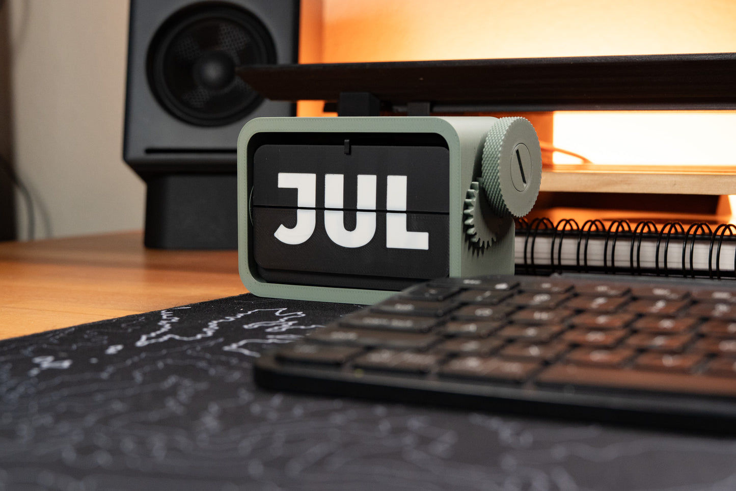 3d printed flip calendar showing "JUL" sitting on desk