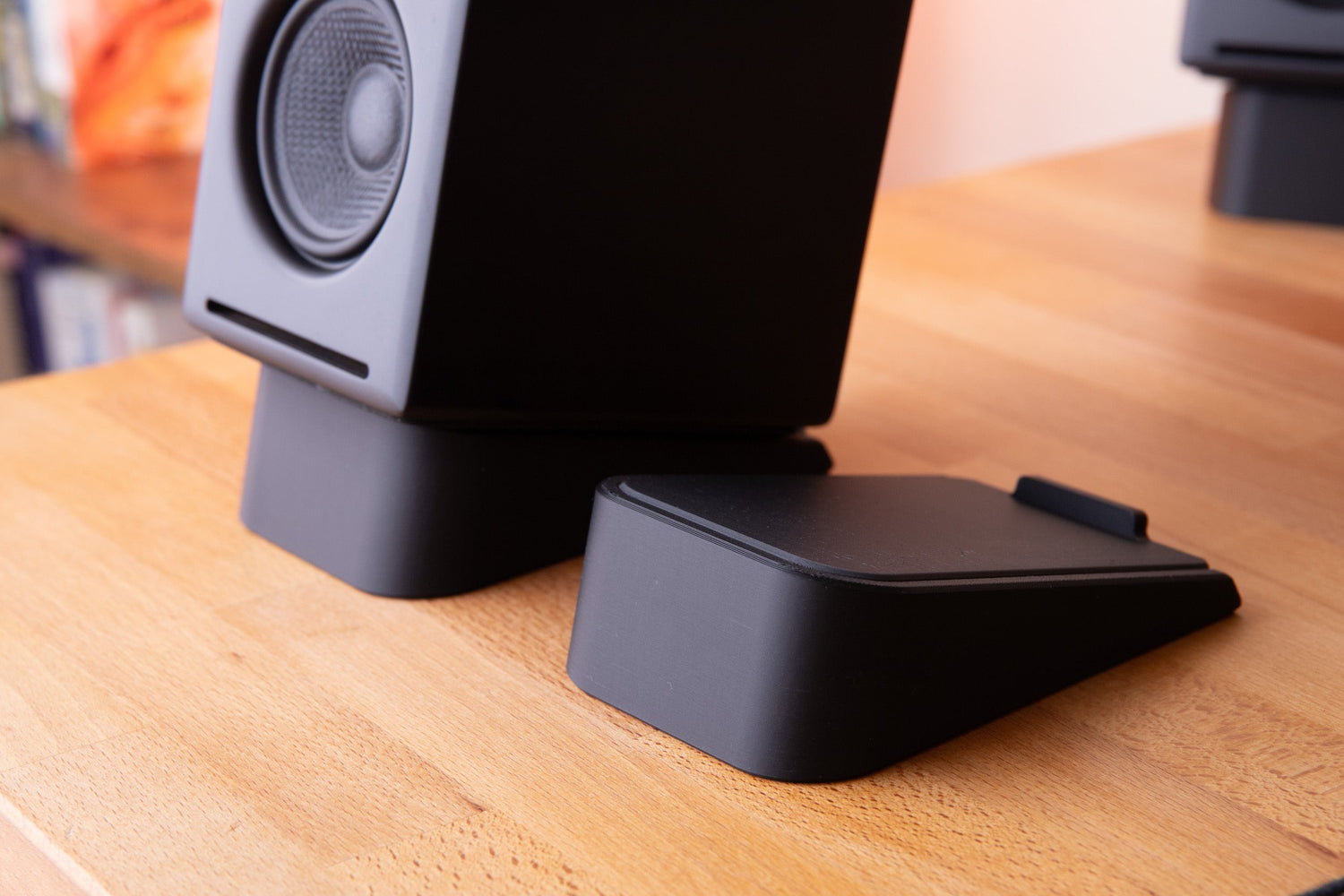 3d printed speaker stand with hidden storage compartment sitting on desk. 