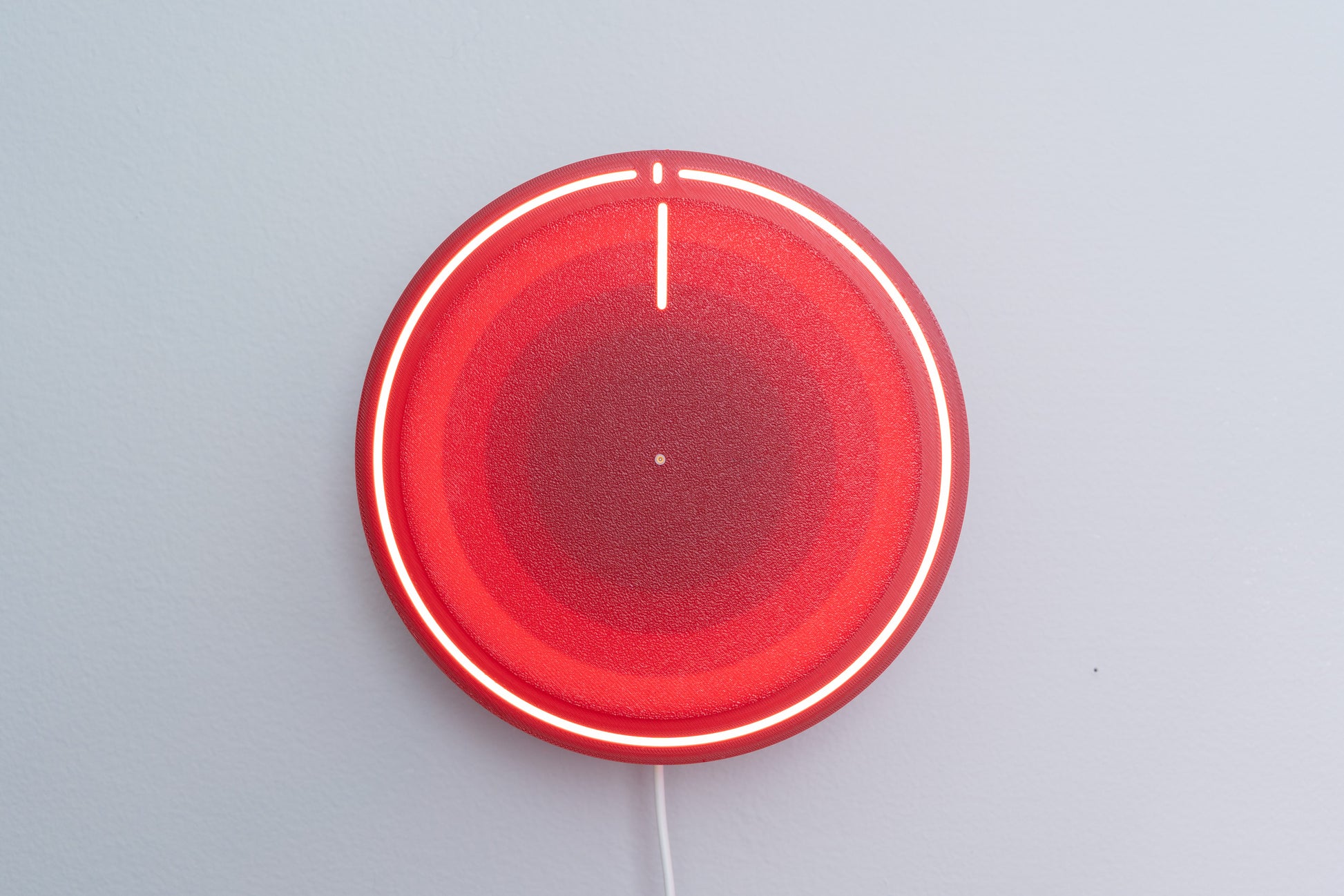 3d printed backlit clock, mounted on gray wall