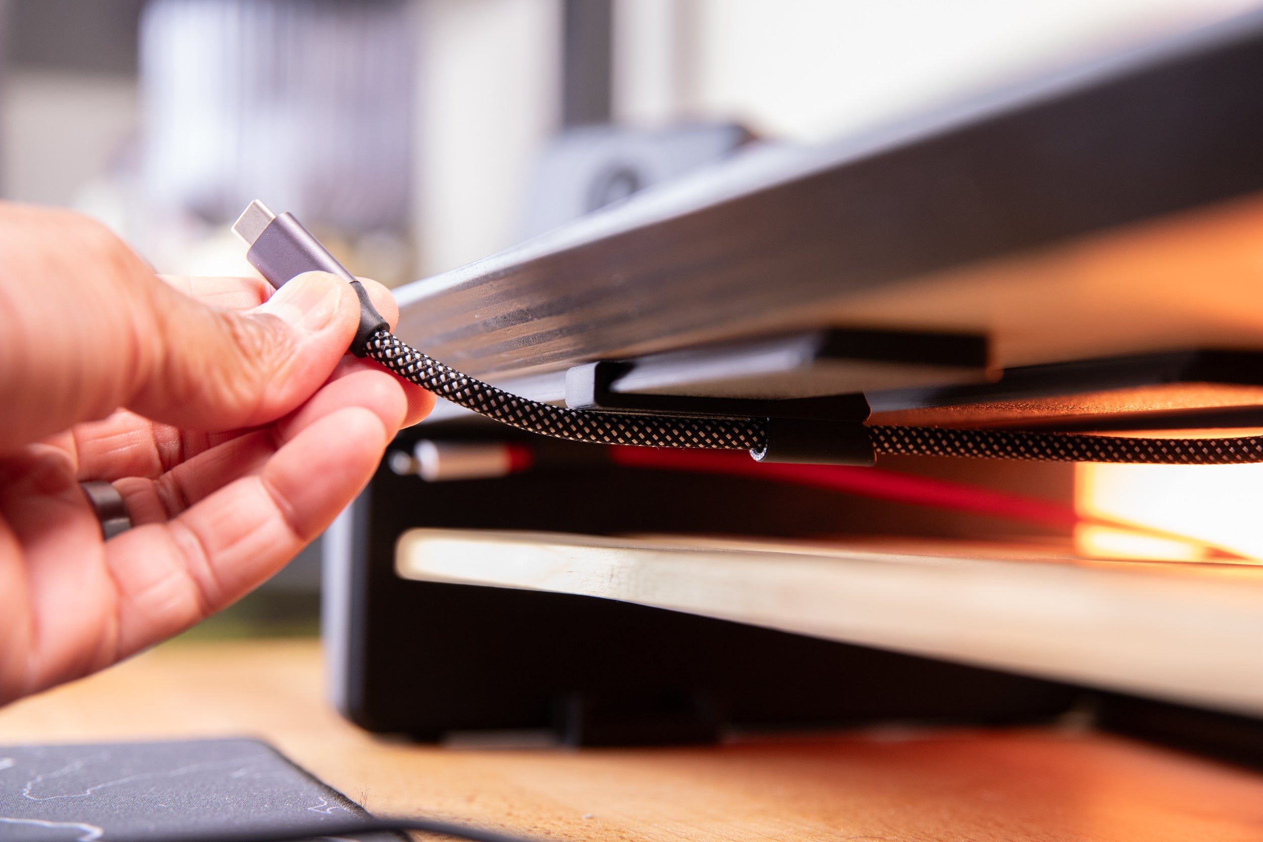 holding usb c cable installed on the desk rail using the cable organizer mount