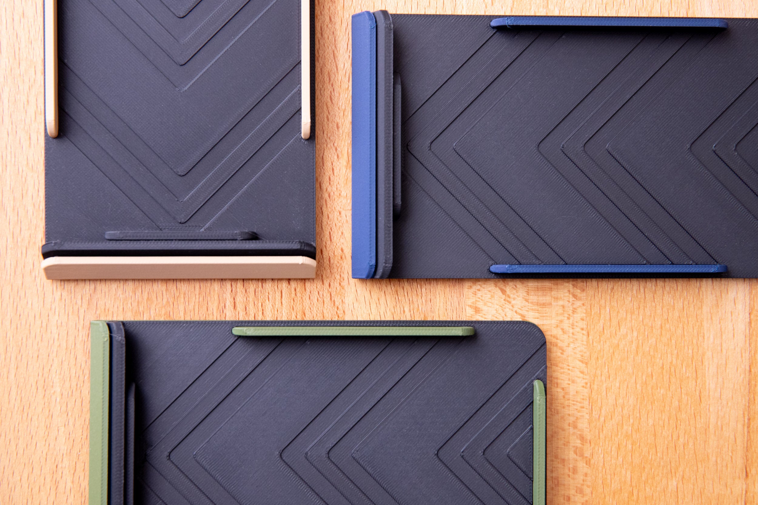 top view of duotone 3d printed taskcard holder in blue, green, and beige with a black base sitting on desk.